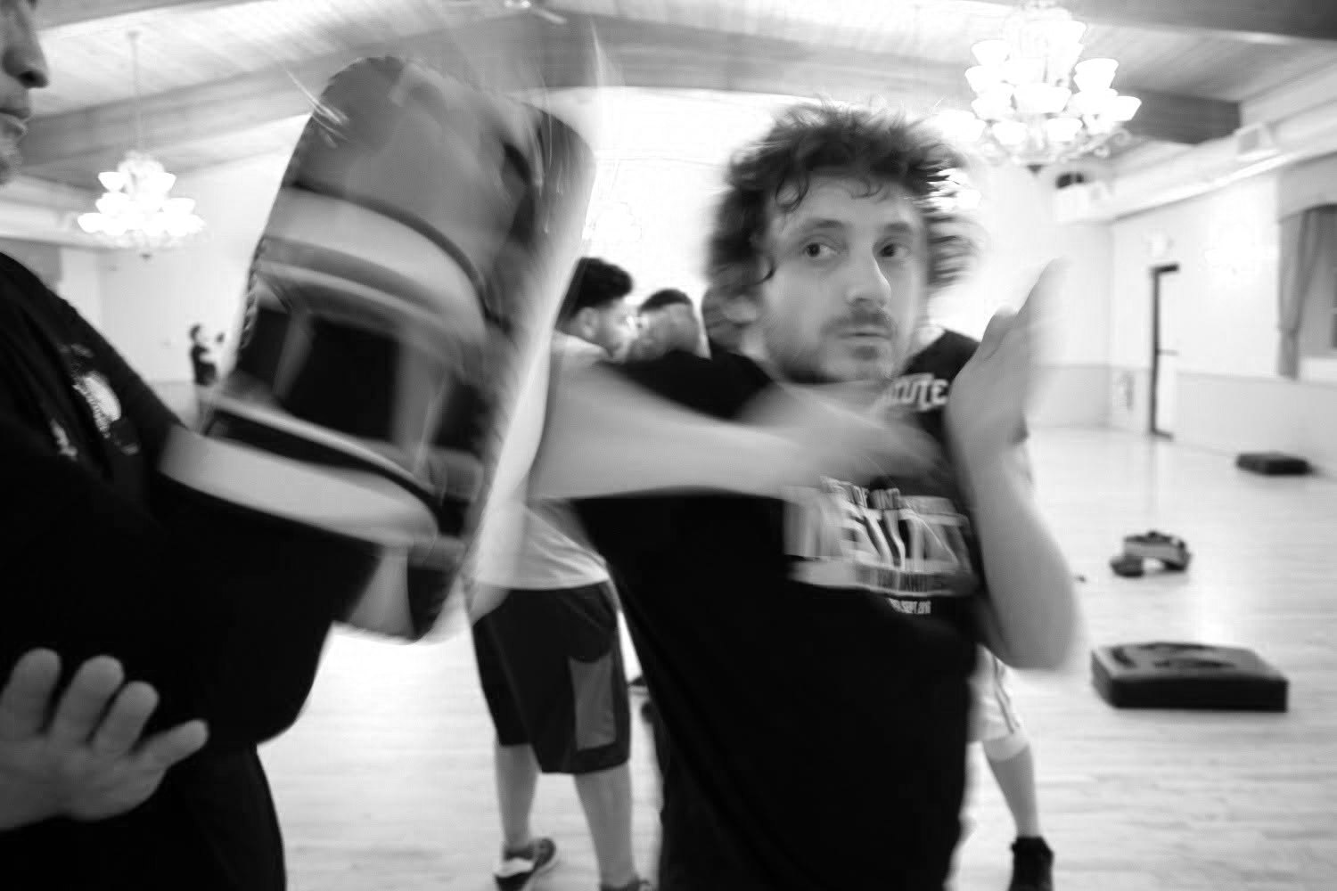 Student striking a kick shield